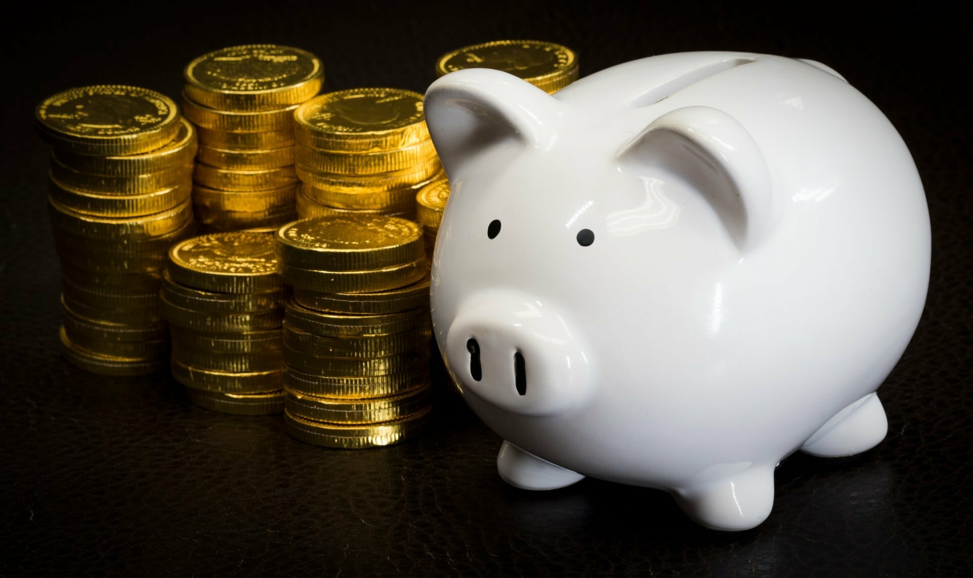 a piggy bank with a lot of coins around it