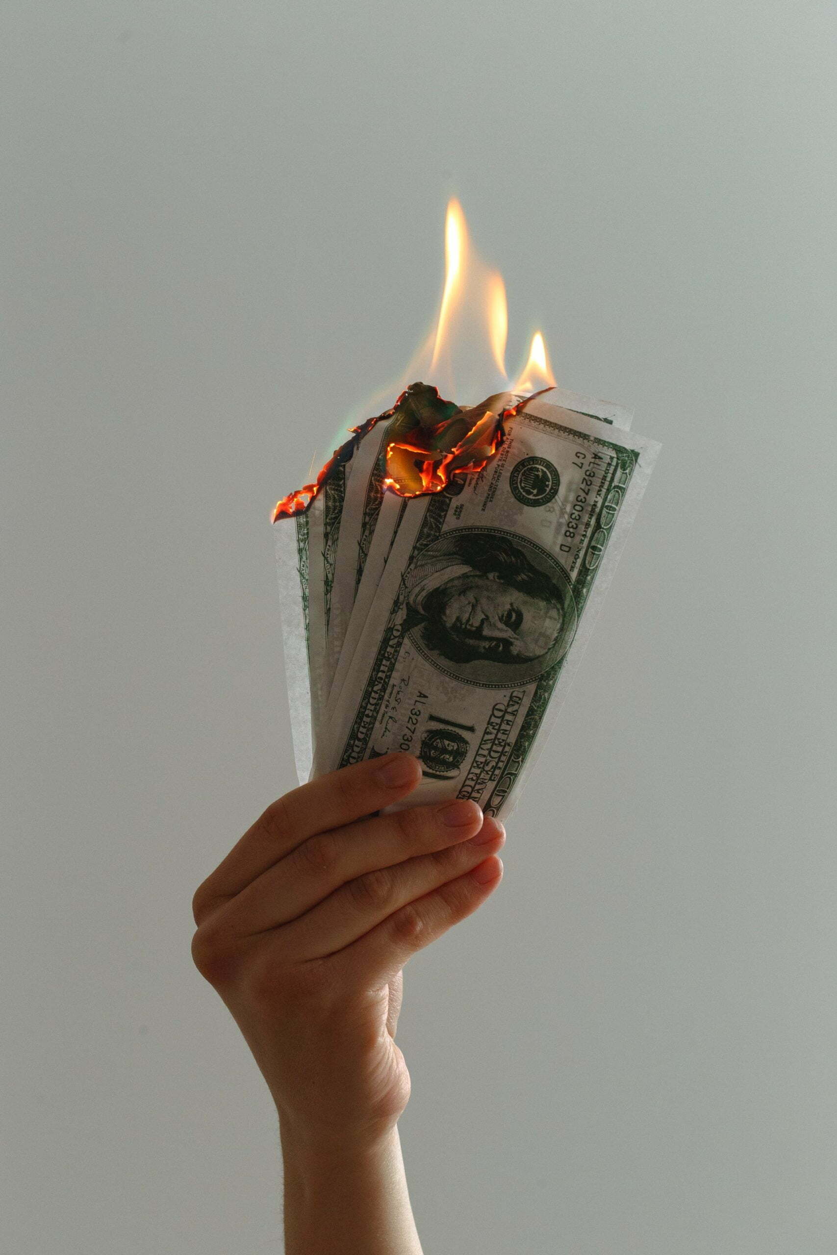 a hand holding a paper with a face on it