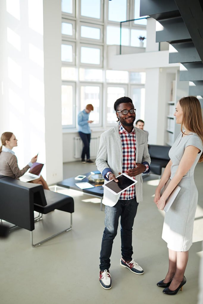 a person standing in a room with people in the background
