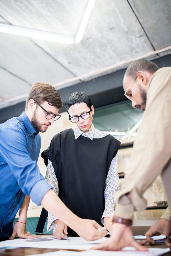 a group of men looking at a map